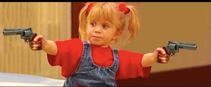 A young girl with pigtails in denim overalls and a red shirt holds up two revolvers with a defiant expression. The image humorously reinforces the post's message about not caring if critics dislike your "long content," using the child's tough, take-no-prisoners pose to convey a "haters gonna hate" attitude.