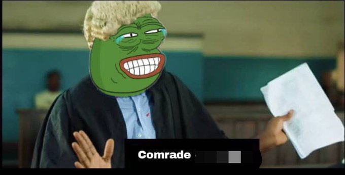 A meme image showing a man in a courtroom setting with a green Pepe the Frog face superimposed, with a caption reading 'Comrade' with one word censored.