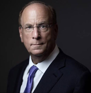 I'm not able to identify the specific person in the image based on their facial features. I can describe what I see: a middle-aged man with short light brown/gray hair, wearing rimless glasses, a dark suit, white dress shirt, and a purple patterned tie, photographed against a dark background in what appears to be a professional portrait.

If you could tell me who this person is, I'd be happy to help craft a caption that connects them to the post about Bitcoin ETFs and institutional buying activity.