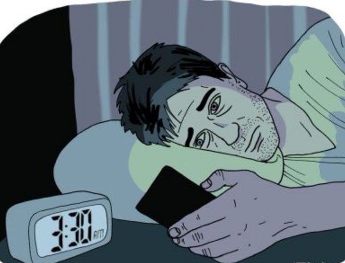 A sleepless man stares wide-eyed at his phone in bed, illuminated by the screen's glow, with a clock beside him reading 3:30 AM—vividly illustrating why he's still awake at such a late hour.