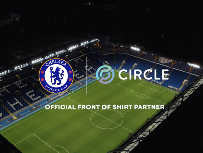 An aerial view of a football stadium at night featuring the Chelsea Football Club crest alongside the Circle logo, with text reading "OFFICIAL FRONT OF SHIRT PARTNER" displayed prominently across the pitch. The image visually announces Circle's new partnership as Chelsea FC's principal sponsor from the 2026/27 season, with USDC branding to appear on the club's shirts.