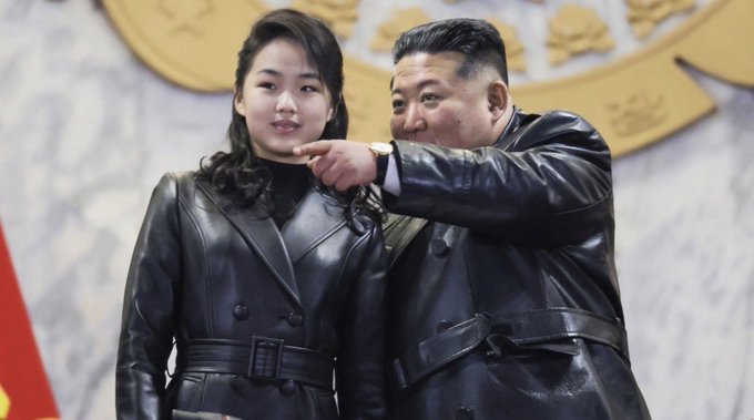 Kim Jong Un points to his daughter, Ju Ae, in this image that is being used to illustrate a post about her potential succession as leader of North Korea. The post also includes the ticker AzpV894DQhitb3G2e7NVurXYjzeNC6hbt3Tfr1jLqJRk.