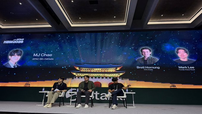 A panel discussion at 'KBW 2025' featuring speakers MJ Chae (APAC BD, DeGate), Brett Hornung (COO, Korbit), and Mark Lee (Founder, Purple House) seated on stage in front of a traditional Korean palace backdrop.