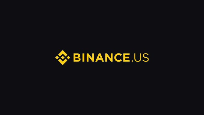 A Binance.US logo displayed in gold text on a dark black background.