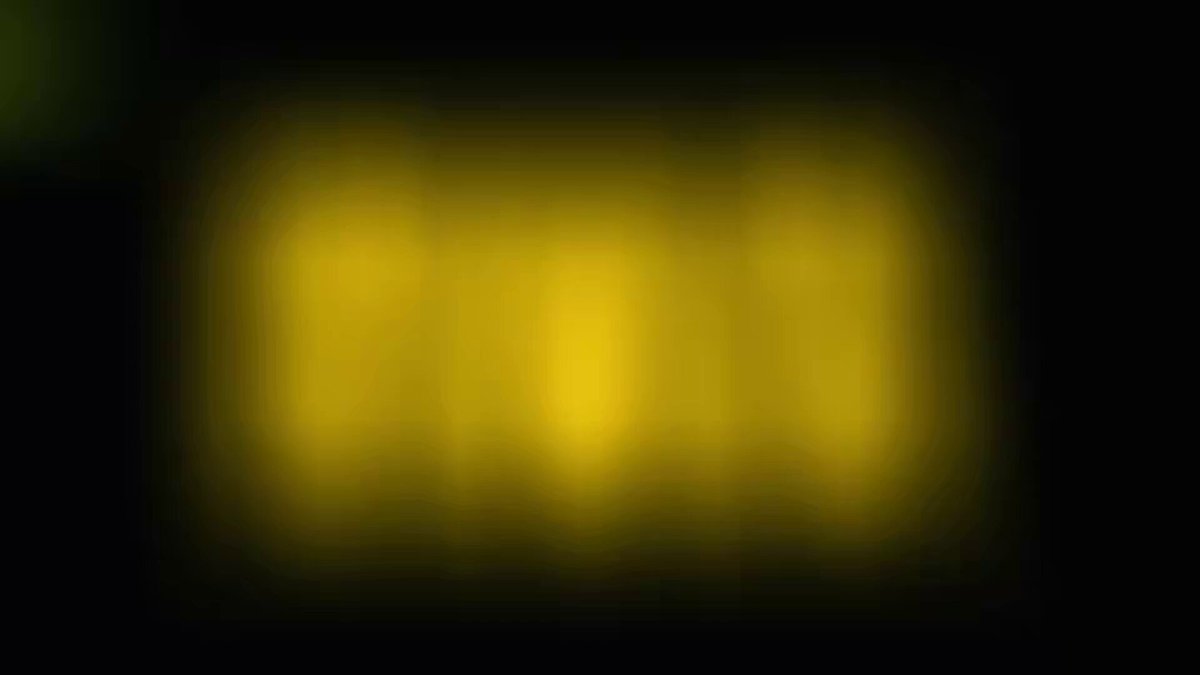 The image shows a yellow rectangle with black text, which appears blurry due to the low-quality camera used to capture the photo. The background of the image is dark gray, making the yellow rectangle stand out prominently. The caption provided after the image reads "感谢 @zhuifei008 #RWA 万市值喊的现实资产代币化 #RWA 今天早上690万市值".