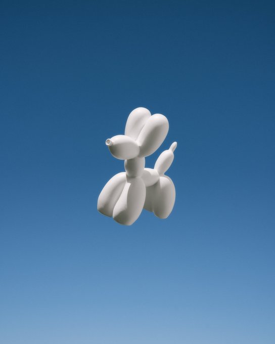 A 3D-rendered white balloon animal in the shape of a dog floats against a clear, gradient blue sky.