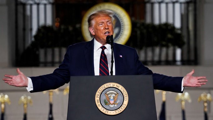 The image shows a man standing at a podium, giving a speech or addressing an audience. He appears to be wearing a suit and tie, suggesting a formal event or occasion. The background of the image features a clock with the hands pointing towards 12 o'clock. There is also a text overlay in the image that reads "Trump administration just confirmed they are removing all regulatory barriers against crypto". This message seems to be related to the man speaking at the podium and could be interpreted as a statement about the Trump administration's stance on cryptocurrencies or other digital assets.

The main focus of the image is the man giving his speech, with the clock in the background providing context for the time. The text overlay adds an element of intrigue and raises questions about the content of the speech itself.