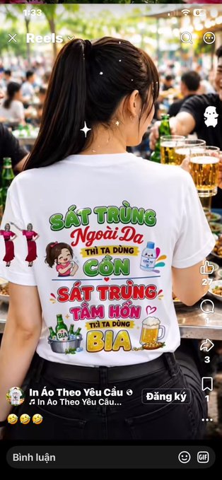 A screenshot of an Instagram Reel shows a woman from behind wearing a white t-shirt printed with Vietnamese text including "SẤT TRÙNG Ngoại Đa THÌ TA DÙNG CỒN SẤT TRÙNG TÂM HỒN THÌ TA DÙNG BIA", set in a crowded venue with beer glasses.