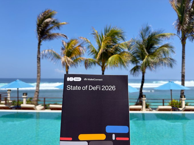 A "State of DeFi 2026" report by WalletConnect is held up against a tropical Bali backdrop with palm trees, a pool, and beach umbrellas, illustrating WalletConnect's presence at CoinfestAsia where attendees can visit their booth, try WalletConnect Pay, and receive exclusive Bali merchandise.