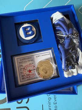 A blue gift box from BTSE contains a gold-colored commemorative coin (marked "20MG") displayed in a certificate holder with a red star stamp, alongside a blue "B" branded pin and a rolled blue item in plastic wrapping. The post celebrates BTSE's thoughtful Mid-Autumn Festival gesture of sending a small gold "big pancake" to the crypto community, emphasizing that even though the 20mg gold has minimal monetary value, the symbolic gesture is perfect for the industry.