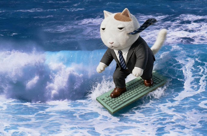 A humorous edit of a cat in a business suit and tie surfing on a green keyboard through ocean waves.