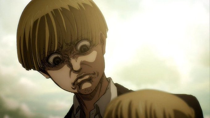 A dramatic close-up of an anime character with blonde hair looking downward with an intense, shocked expression.