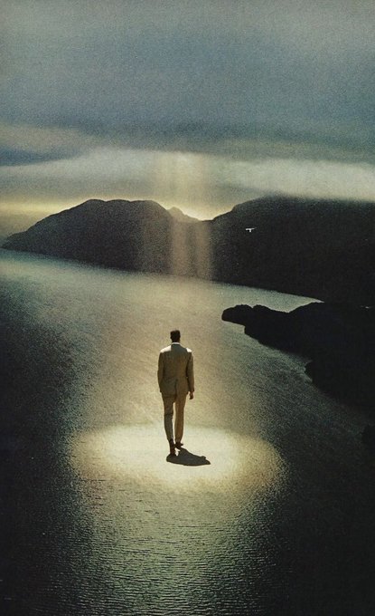 This digital art piece features an abstract depiction of a person walking towards an island while the light illuminates their face, casting long shadows across the water. The scene takes place next to a mountain range under a cloudy sky, creating a sense of mystery and tranquility as the individual journeys into the distance. As for the post, it says "At the end of it all" which adds a layer of depth and emotion to the artwork. This caption likely implies that the image has some connection or metaphor with the theme of life, self-discovery, or loss, inviting the viewer to reflect on their own experiences and perceptions of these subjects in the context of this visual composition.