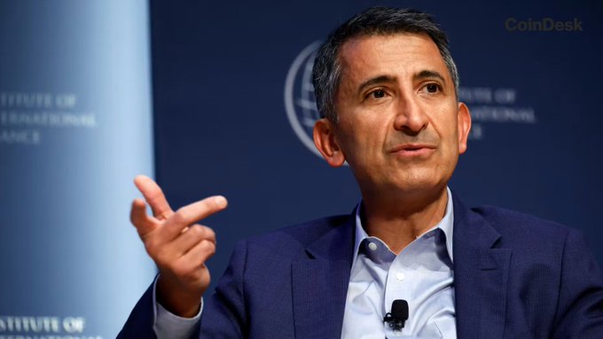 Coinbase Chief Policy Officer Faryar Shirzad is captured mid-gesture at what appears to be an Institute of International Finance event, contextualizing the post's update on the upcoming Senate procedural vote for the CLARITY Act on September 15. The CoinDesk watermark and the man's authoritative speaking pose align with the announcement about ongoing negotiations on the crypto market structure bill's ethics and illicit finance provisions.