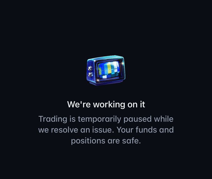 A dark screen with a retro TV icon and text reading 'We're working on it. Trading is temporarily paused while we resolve an issue. Your funds and positions are safe.'