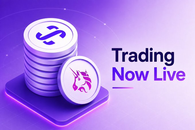 The image features a stack of coins with an unicorn logo on top, surrounded by purple lights that create a purple gradient background. The text "TRADING NOW LIVE" is written above the coins, indicating that trading has been made live for these coins. The image also includes a link to the post where it says "@Uniswap trading is now live".
