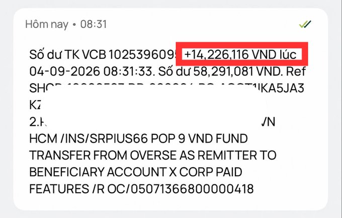 A bank SMS notification in Vietnamese from VCB showing account 1025396091 with a credit of +14,226,116 VND highlighted in red (likely a scam/spoofing alert), with an overseas remittance from X CORP.