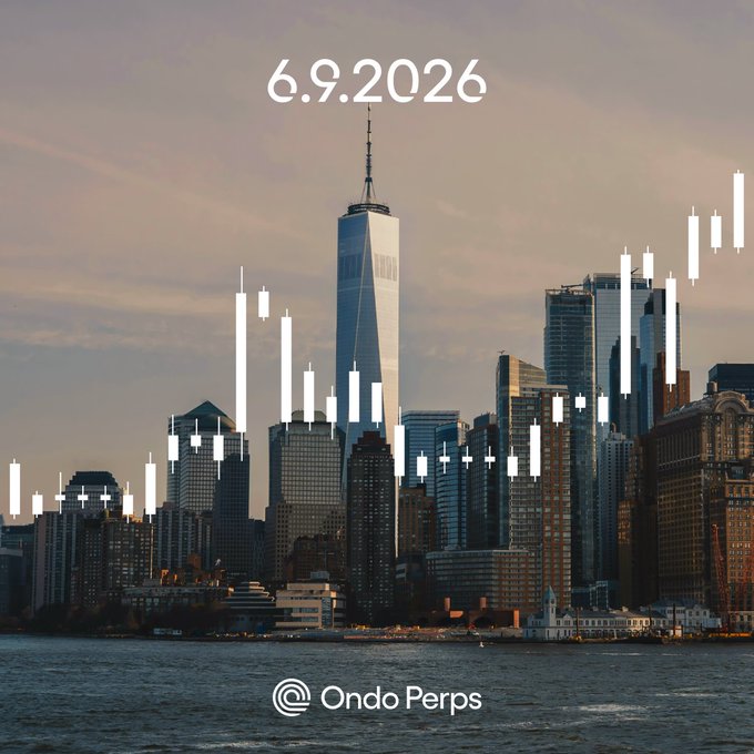 The image shows a city skyline at sunset, with tall buildings and a skyscraper dominating the scene. In the foreground of the photo, there are two candles that appear to be floating or floating in front of the cityscape. The text on the image reads "6.9.2026", which is likely a date or time stamp indicating when the photo was taken.