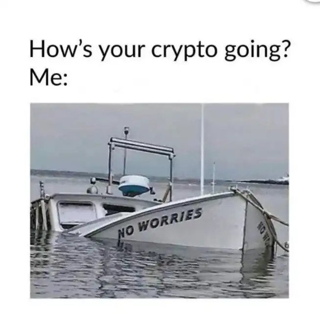 A sinking boat labeled "NO WORRIES" sits half-submerged in the water, humorously mirroring the "just another day in crypto" sentiment by suggesting that despite the crypto market clearly going down, one should simply respond with "no worries."