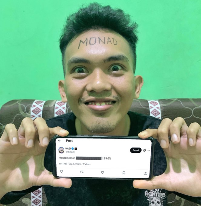 A man with 'MONAD' written on his forehead excitedly holds a phone showing a poll for 'Monad season' at 99.6%.