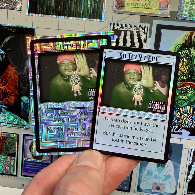 A hand holds up two holographic trading cards titled 'SO ICEY PEPE', featuring a man with a red bandana and diamond chain, with text reading 'If a man does not have the sauce, then he is lost...', surrounded by other scattered cards.