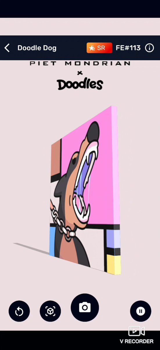 The image shows a phone screen displaying an app called "Doodle Dog". The app features a cartoon dog with its mouth open, giving the impression of teeth gnashing or growling. The background color of the app is pink, which contrasts with the white text on the screen that reads "Doodle Dog" and "x @veve_official x @doodles x Piet Mondrian collab piece". The app also has a camera icon in the bottom right corner, suggesting it could be used for taking photos or videos.
