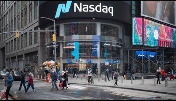 The exterior of the Nasdaq MarketSite building is shown in Times Square, featuring the 'Nasdaq' logo and ticker display with pedestrians and an American flag on the street below.