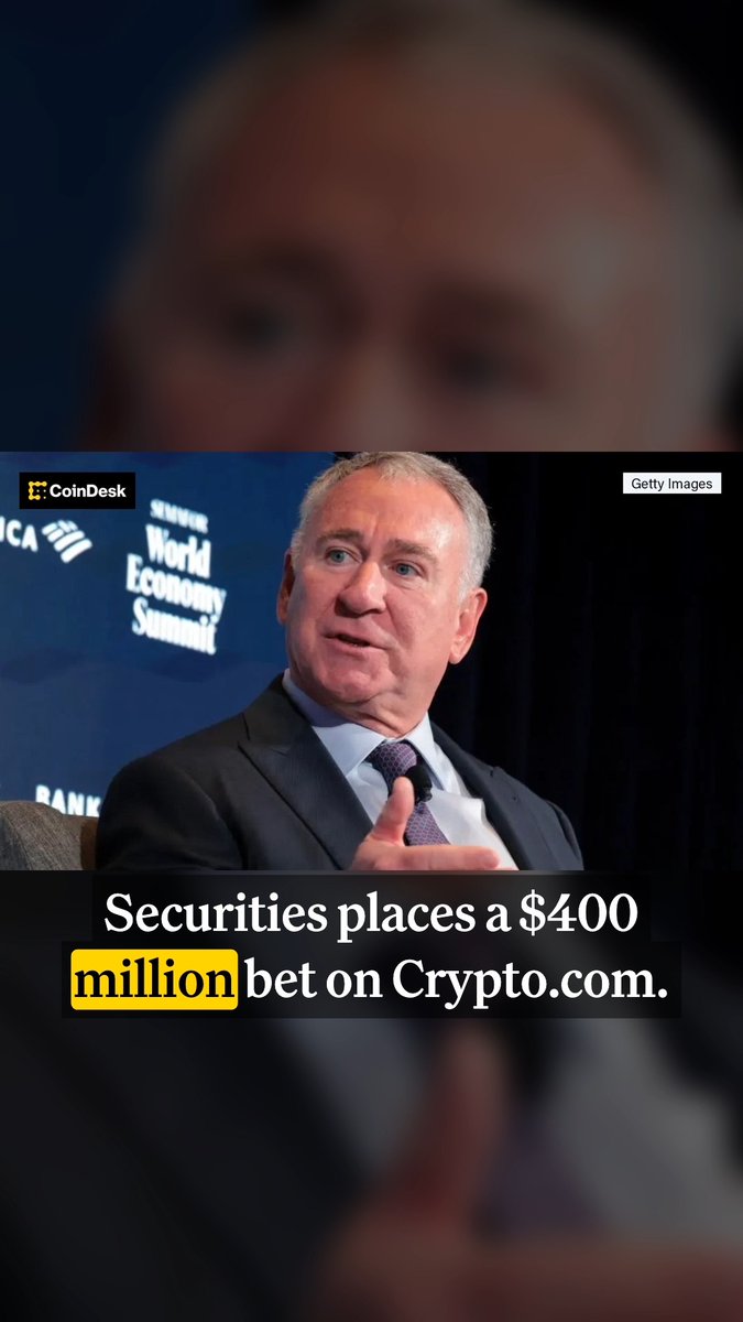 A blurred-background CoinDesk/Getty Images news clip showing a man at a World Economic Summit panel with the headline 'Securities places a $400 million bet on Crypto.com.'