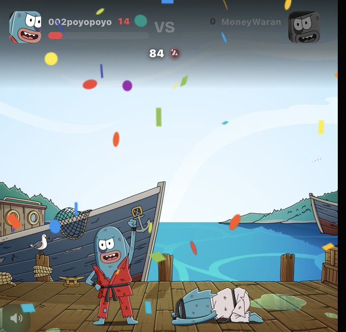 A screenshot from a mobile game battle between '002poyopoyo' (14) and 'MoneyWaran' (0) with a score of 84, showing cartoon fish characters on a dock with confetti falling.