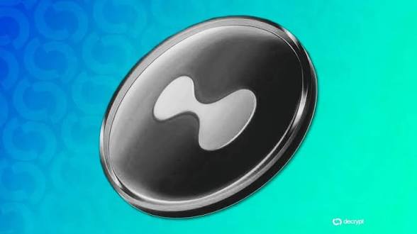 A 3D rendering of a silver and black coin featuring a curved, hourglass-like logo on a gradient blue and teal background, watermarked 'decrypt'.