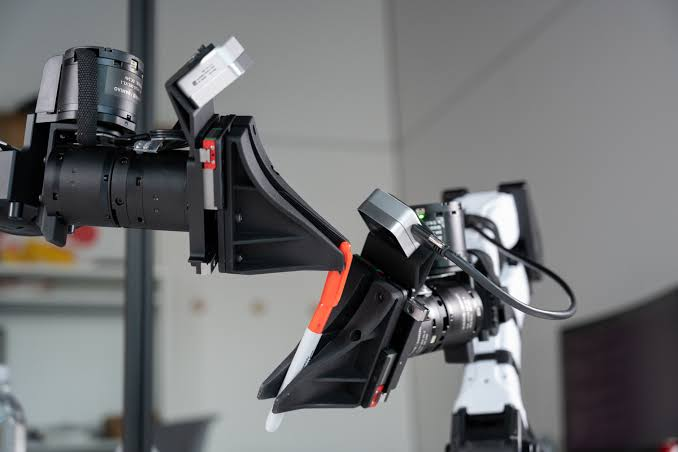 Close-up photograph of professional broadcast camera equipment mounted on a studio rig.