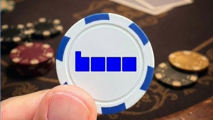 A hand holds a blue and white poker chip featuring the text "base," with playing cards and other casino chips visible in the background, symbolizing the staking of one's bet or investment in the Base ecosystem as highlighted in the accompanying post.