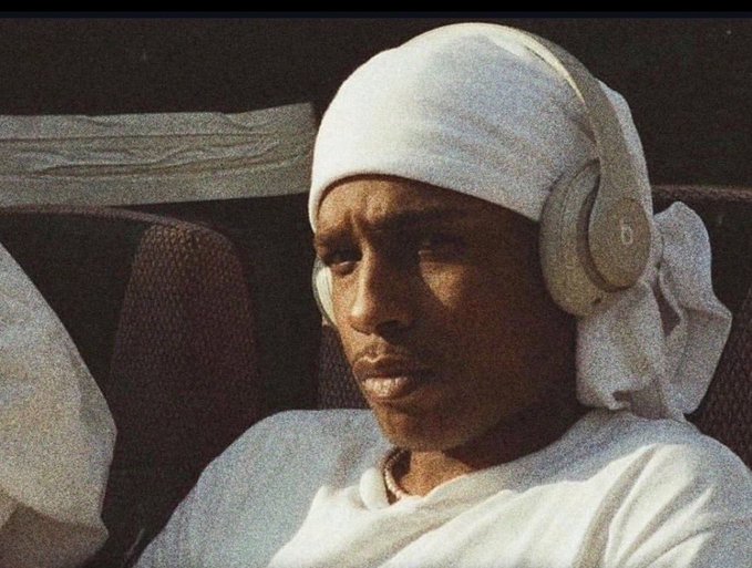 A man in a durag wearing Beats headphones with the "b" logo visible sits in deep contemplation, paired with a post playfully warning that missing opportunities like $Ansem is just part of the grind—setting a humorous, unbothered tone for the day.