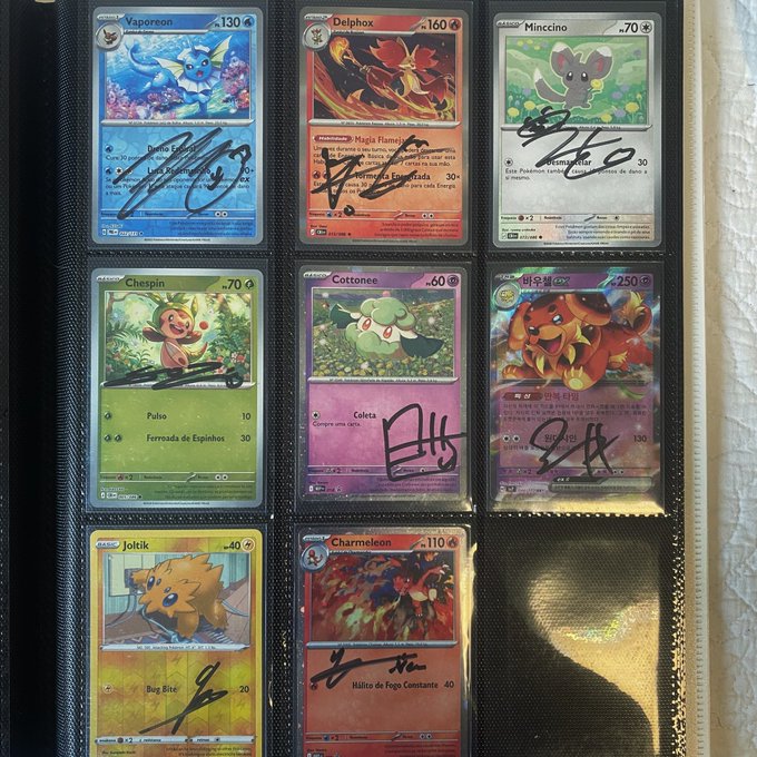 A binder page displaying eight signed Pokémon cards, including Vaporeon, Delphox, Mimccino, Chespin, Cottonee, Magmortar, Joltik, and Charmeleon.