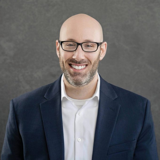 A professional headshot of a smiling bald man with glasses, a beard, and a navy blazer over a white shirt, which appears to be Jake Chervinsky, the Hyperliquid Policy Center CEO referenced in the post. The image pairs with the accompanying text about Hyperliquid's CEO discussing how successful blockchain infrastructure could compel traditional exchanges to adapt.