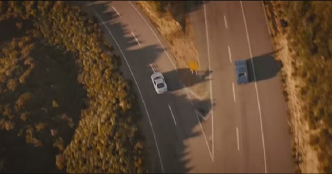 The image shows a car driving down an empty road, with another car following behind it. The two cars are positioned at different points along the road, suggesting that they might be heading towards or away from each other. In addition to the vehicles, there is also a person visible in the scene, possibly walking on the side of the road. The image does not provide any information about the content of the post, but it seems to be related to a conversation between two people who are going their separate ways after refusing to part with each other.