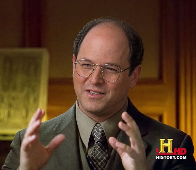 A man in a suit and glasses gestures with his hands while speaking, with a History Channel 'H HD' watermark visible.