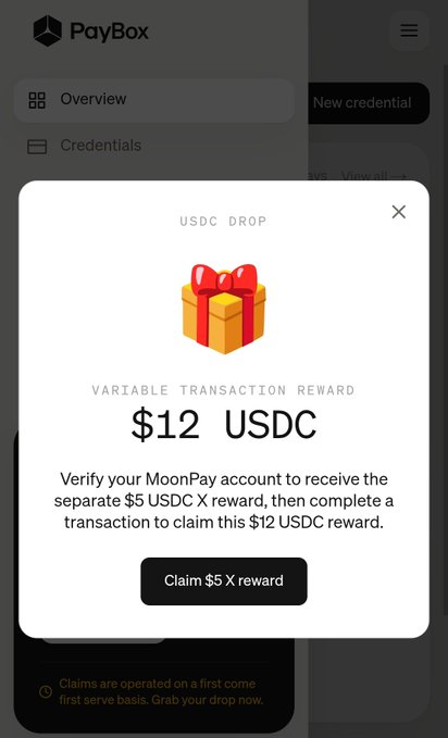 Mobile screenshot of PayBox app showing a 'USDC DROP' popup offering a $12 USDC variable transaction reward with a 'Claim $5 X reward' button.