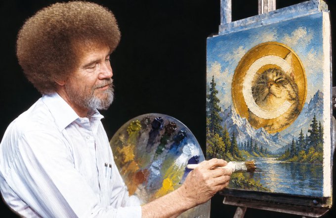 Bob Ross is shown painting a mountain landscape that features a cat's face inside the sun, holding a paintbrush and palette.