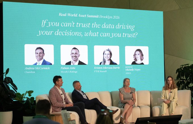 Panel discussion at the 'Real-World Asset Summit Brooklyn 2026' with the question 'If you can't trust the data driving your decisions, what can you trust?' displayed above portraits of speakers Andrew McCormick (Chainlink), Fabian Astic (Moody's Ratings), Kristen Merzava Barrie (FTSE Russell), and Michelle Noyes (AMA).