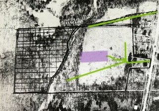 An aerial map or site plan showing property boundaries, a highlighted rectangular area in purple, and green arrows indicating routes or boundaries.