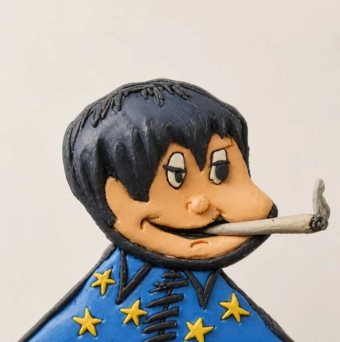 A handmade clay sculpture of a cartoon character with dark shaggy bangs, a mischievous grin, and a cigarette hanging from his mouth, wearing a blue outfit adorned with yellow stars—appearing to be a stylized interpretation of Eric Burdon of The Animals, tied to the post's shoutout to the Clay Factory NFT mint and Iron Allies collection.