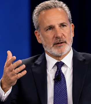 The image features a man dressed in a suit and tie giving a speech or presentation. The man has gray hair and is wearing a blue tie with white polka dots. He appears to be speaking into a microphone, suggesting that he might be addressing an audience during a formal event or gathering.