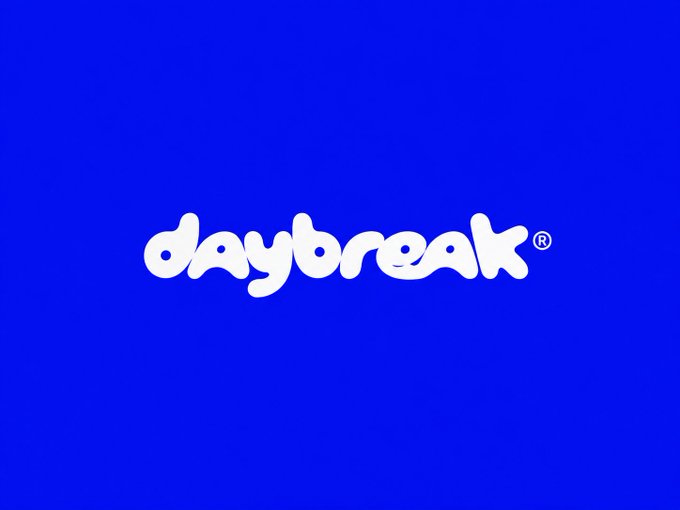 The "daybreak®" logo in white bubbly lowercase letters centered on a solid blue background.
