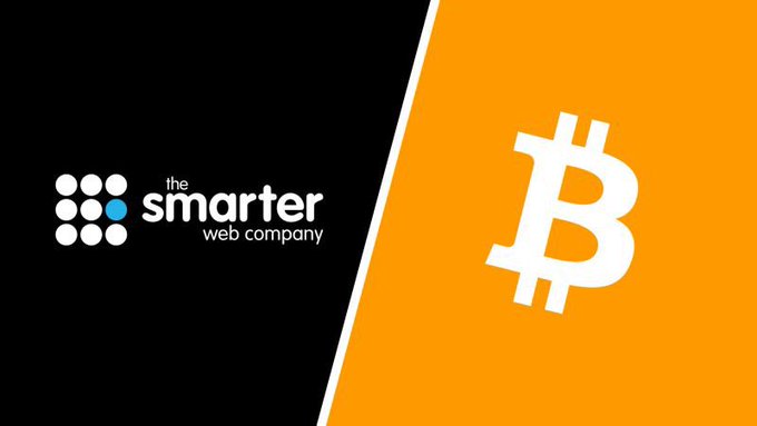 A split black and orange graphic showing 'the smarter web company' logo on the left and a white Bitcoin (₿) symbol on the right.