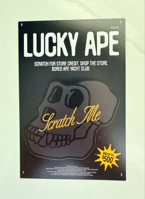 A black scratch-off card titled "LUCKY APE" with the text "Scratch for store credit. Shop the store. Bored Ape Yacht Club." featuring a skull illustration and "Win up to $500" in a starburst, directly tying to the post's playful question about whether the viewer is a "Lucky Ape."