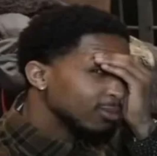 A reaction image showing a man with his hand on his forehead, appearing exasperated or in disbelief.