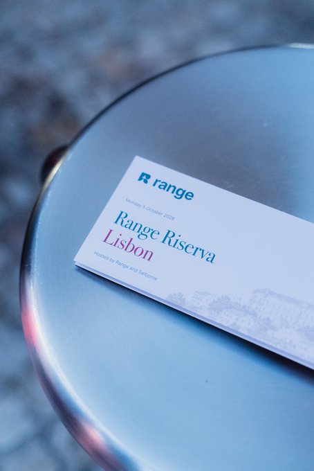 A card labeled 'Range Riserva Lisbon, Monday 5 October 2026, Hosted by Range and Welcome' rests on a metallic surface.