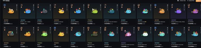 The image features a long row of small, colorful figurines or toys displayed side by side against a gray background. The objects vary in size and color, creating an interesting visual effect. The text "Japanese axies are some of the most stable nfts I've observed in any ecosystem." is present within the image, which seems to be related to the collection of these figurines or toys.