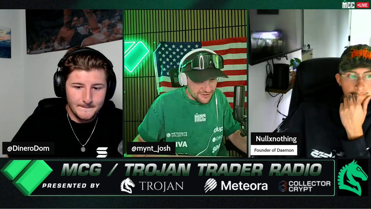 The image features a group of three men wearing headphones, with one man sitting down and another standing up. They are all wearing green shirts that say "MCG" on them. The background shows an advertisement for a cryptocurrency called "solana". The caption of the image reads "$Daemon is so undervalued -- retail crypto suddenly waking up to the next wave of affordable moon projects on @solana - @XRP_Alerts pay attention".